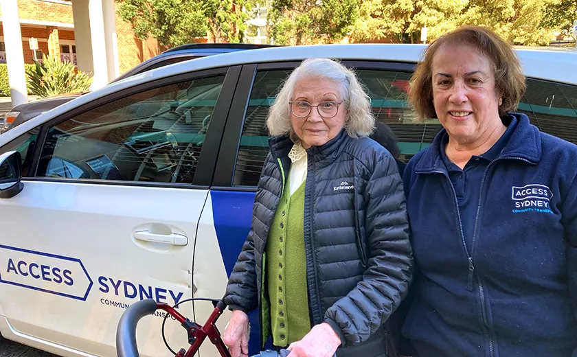 Client and driver standing next to a car